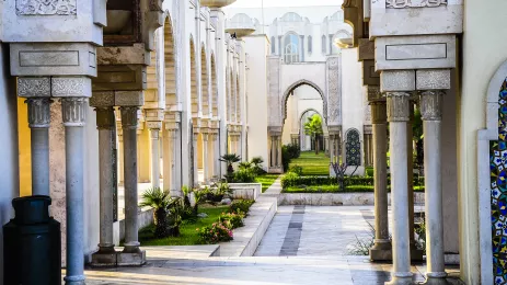 the archways by Hassan II Mosque leading to a green garden