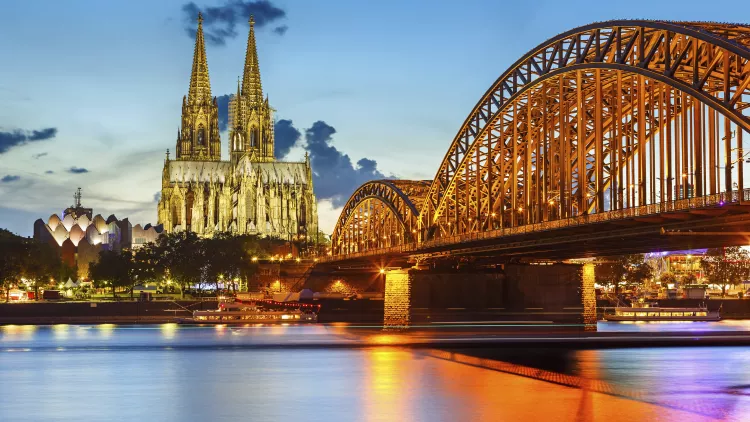 Cologne Cathedral and Hohenzollern bridge illuminated in Cologne, Germany