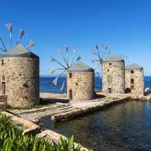 Famous stone windmills of Chios island overlooking the sea in Greece