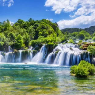 Croatian Krka Park waterfalls surrounded by green trees