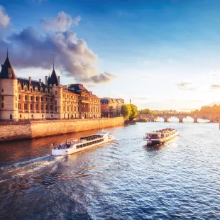 An image of two ships crossing the Seine River, during the day