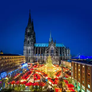 Christmas market and Catholic cathedral at night in the city of Cologne, Germany