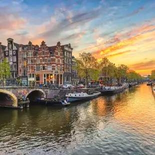 Sunset city skyline at canal waterfront in Amsterdam, Netherlands