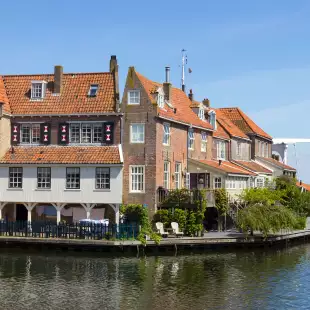 Dutch canal house under a calm blue sky