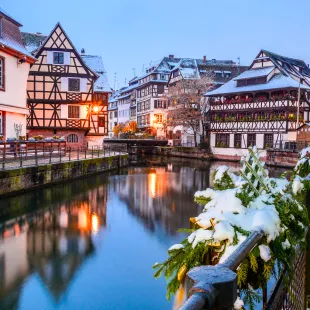 Canal and illuminated buildings during a Christmas market in Strasbourg, France