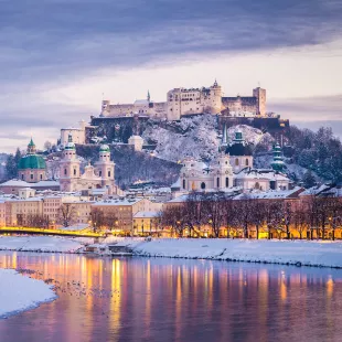 Classic view of Salzburg and Festung Hohensalzburg fortress illuminated at Christmas time in Austria