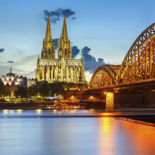 Cologne Cathedral and Hohenzollern bridge illuminated in Cologne, Germany