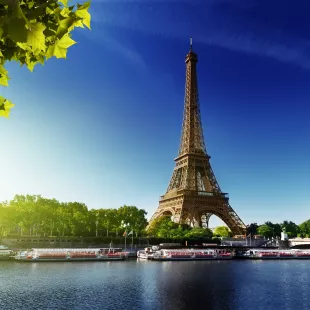 The River Seine and the Eiffel Tower during sunrise in Paris, France