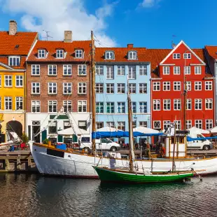 Colourful row of houses and canal with boats in Copenhagen, Denmark