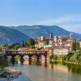 Old bridge in Bassano del grappa in Italy with the mountain peaks in the distance