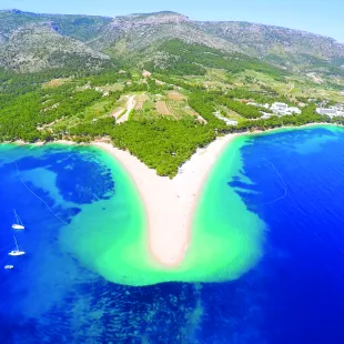 Beautiful large Golden Horn beach along the coastline of Croatia with blue waters