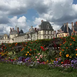 Palace of Fontainebleau and garden of colourful flowers in France