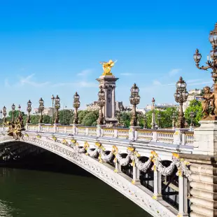 Pont Alexandre III bridge with ornate Art Nouveau lamps over the river Seine in Paris, France