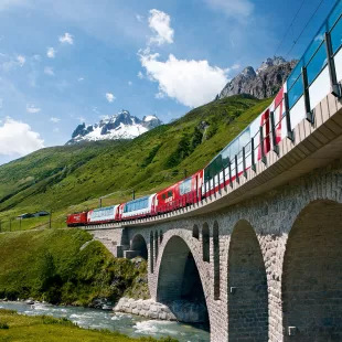 Switzerland railway Glacier Express train travelling through the Alps