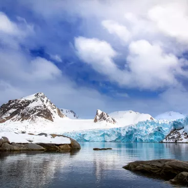 Mountains, snow and blue glacial ice in Svalbard 