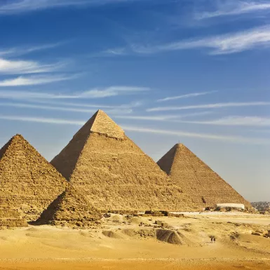 Desert view of the Great Pyramids of Giza under a clear sky