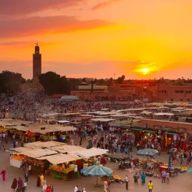 Jamaa el Fna market square at golden hour in Marrakesh, Morocco.