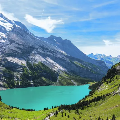 Bright blue waters of Oeschinen Lake and mountains in Switzerland