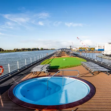 Sun deck with mini golfing area and round pool aboard the Thomas Hardy ship