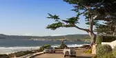 Carmel By The Sea coastal path with trees, ocean and blue skies, California, USA