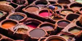 Man working in leather tanneries in medina Fez, Morocco