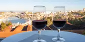 Two port wines in glasses with view of the Douro river and city of Porto, Portugal