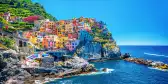 Colourful buildings along the cliffside of Cinque Terre over the Mediterranean sea