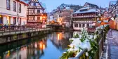 Canal and illuminated buildings during a Christmas market in Strasbourg, France