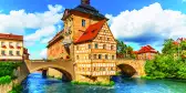 City Hall building with two bridges over the Regnitz river in Bamberg town, Germany