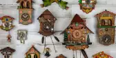 Antique cuckoo clocks on a white wall