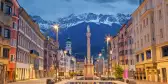 Innsbruck, Austria, during twilight with European Alps in the background.