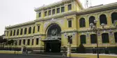 Saigon Central Post Office, large yellow building with white accents, Vietnam.