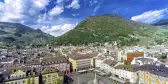 Aerial view of the Bolzano town, buildings and mountainous background