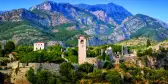 Aerial shot of old bar town with mountains and vegetation in Montenegro