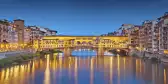 Panorama of Ponte Vecchio bridge and houses at twilight in Florence, Italy