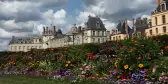 Palace of Fontainebleau and garden of colourful flowers in France