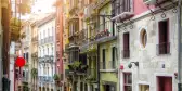 Rows of buildings in narrow ancient street in Pamplona city, Spain