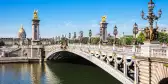 Pont Alexandre III bridge with ornate Art Nouveau lamps over the river Seine in Paris, France