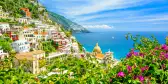 Positano on Amalfi coast with blurred flowers on foreground in Campania, Italy