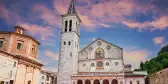 The medieval cathedral of Santa Maria Assunta with a colourful evening sky in Umbria, Italy.