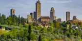 San Gimignano, a small walled medieval hill town with lush vegetation in Siena, Italy