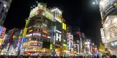 Tokyo main street filled with pedestrians making their way under the neon lights