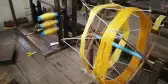 Silk weaving machine in Cambodia with yellow coloured thread on it