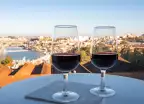 Two port wines in glasses with view of the Douro river and city of Porto, Portugal