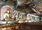 Interior of the Dambulla Golden Cave Temple with rows of golden Buddha statues and painted ceilings, Sri Lanka, South Asia.