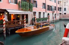 Exterior of the Splendid Venice Hotel and small boat in Venice, Italy