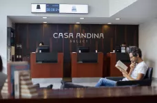 Hotel reception at Casa Andina featuring a man relaxing reading a book