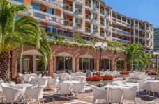 Exterior of the TonelliHotels with patio table and chairs