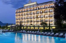 Night poolside view of the Grand Hotel Bristol with a distant view of the Alps, Italy