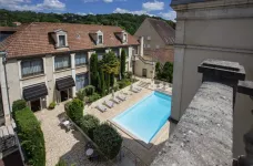 Exterior of Hotel Le Renoir and outdoor pool in Sarlat-la-Canéda, Dordogne, France